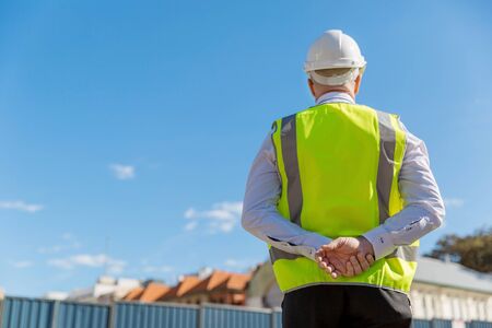 Engineer builder wearing safety vest at construction site
