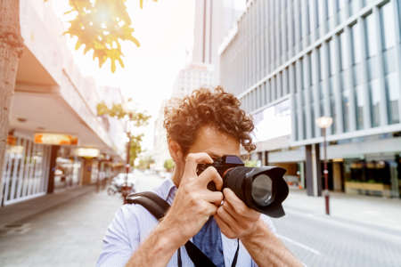 Professional photographer taking picture in cityの写真素材