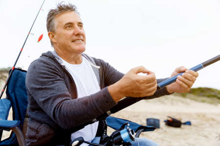 Picture of fisherman fishing with rodsの写真素材