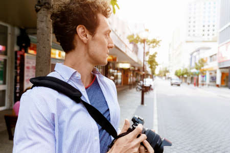 Professional photographer taking picture in cityの写真素材