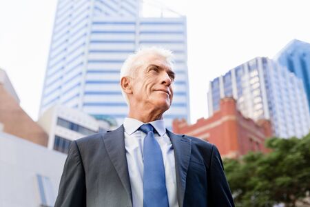 Portrait of confident businessman in suit outdoorsの写真素材