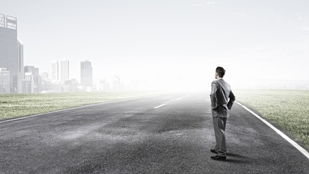 Young businessman choosing one of many opened doorsの写真素材