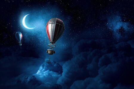 Aerostats as travel concept flying in dark night skyの写真素材