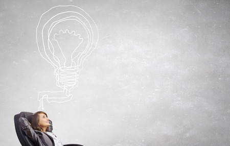 Thoughtful businesswoman and drawn thoughts out of her headの写真素材