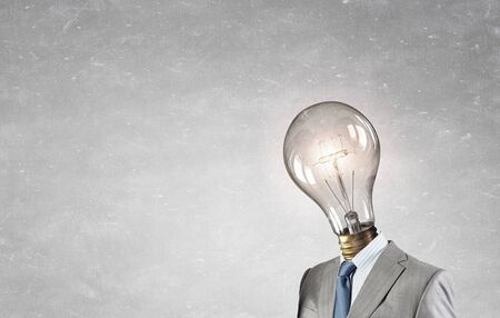 Businessman with light electric bulb instead of head as symbol of bright ideaの写真素材
