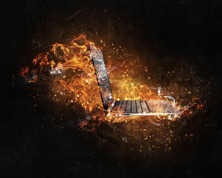 Concept of electronics break with device in fire flamesの写真素材