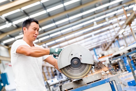 portrait of asian worker in production plant working on the factory floorの写真素材