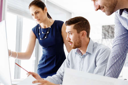 Business people working and discussing in modern office