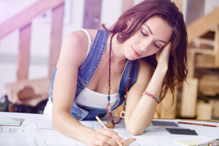 Young pretty woman working at her desk in her office