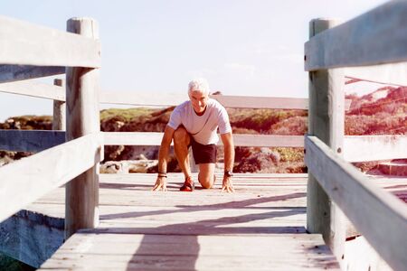 Male runner getting ready to start his raceの写真素材