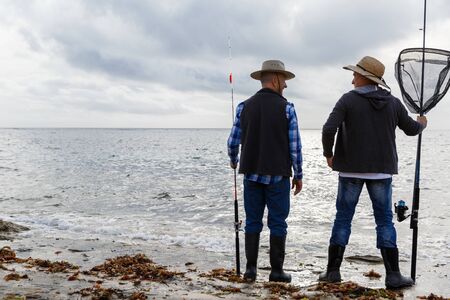 Picture of fishermen fishing with rodsの写真素材