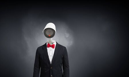Portrait of camera headed man in suit as security conceptの写真素材