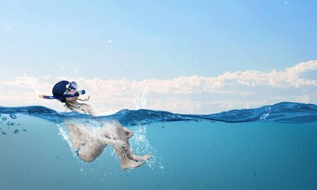 Kid girl of school age in diving mask having funの写真素材