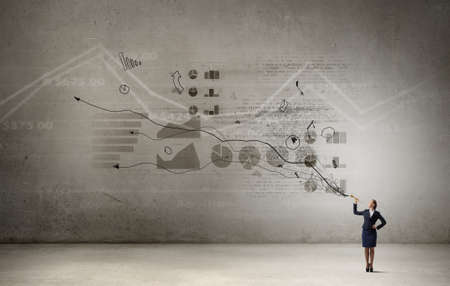 Young pretty businesswoman playing melody on trumpetの写真素材