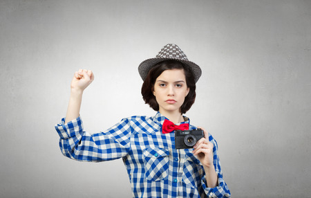 Pretty young girl in casual with retro vintage cameraの写真素材