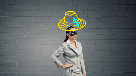 Young thoughtful businesswoman with black mask on faceの写真素材