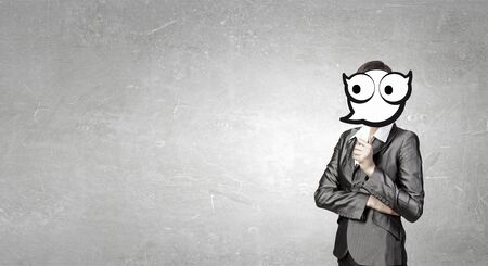 Businesswoman in suit hiding her face behind maskの写真素材