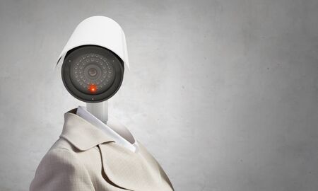 Portrait of camera headed woman in suit as security conceptの写真素材
