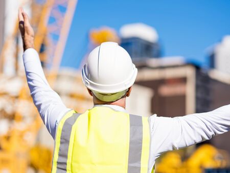 Engineer builder wearing safety vest at construction site