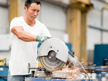 portrait of asian worker in production plant working on the factory floorの写真素材