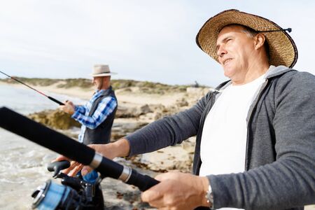 Picture of fishermen fishing with rodsの写真素材