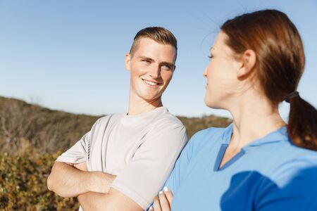 Young couple on beach training and exercising togetherの写真素材