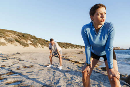 Young couple on beach training and exercising together