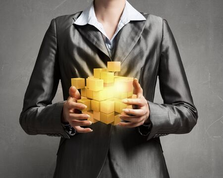 Close view of businesswoman shows cube as symbol of modern technologyの写真素材
