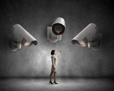 Young woman in room under CCTV camera control