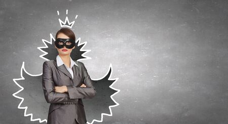 Young businesswoman with black mask on faceの写真素材