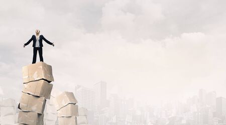 Businesswoman and big stacks of carton boxesの写真素材