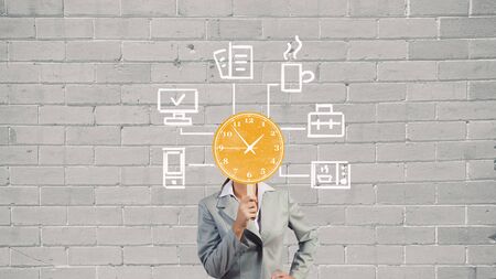 Businesswoman with card instead of face presenting time conceptの写真素材