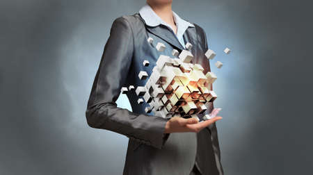 Close view of businesswoman shows cube as symbol of modern technologyの写真素材