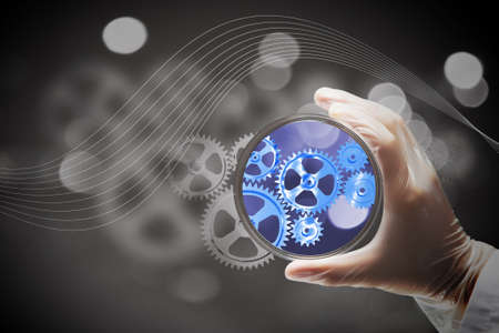 Scientist doctor hand on science background holds glass dishの写真素材