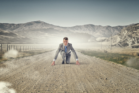 Young businessman outdoor ready to run raceの写真素材
