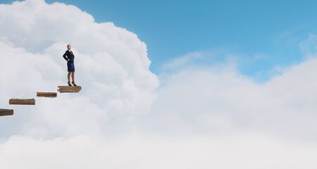 Young confident businesswoman with hands on waistの写真素材