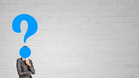 Businesswoman in suit with question mark instead of headの写真素材