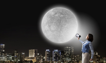 Young businesswoman in suit proclaiming something in megaphoneの写真素材