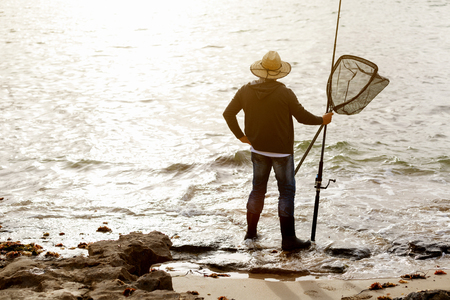 Picture of fisherman fishing with rodsの写真素材