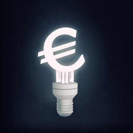 Glowing light bulb with euro sign on black backgroundの写真素材