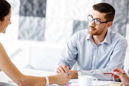 Business people working and discussing in modern officeの写真素材