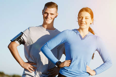 Young couple on beach training and exercising togetherの写真素材