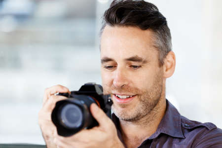 Professional photographer taking picture in cityの写真素材