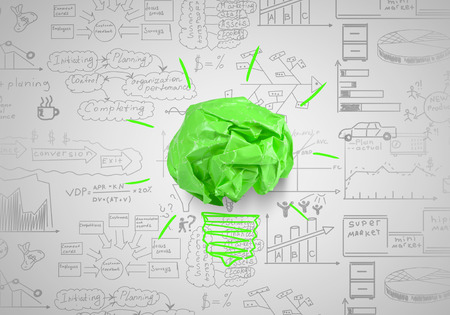 Light bulb with crumpled paper balls on white backgroundの写真素材