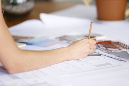 Hand of female designer working at her deskの写真素材