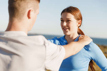 Young couple on beach training and exercising togetherの写真素材