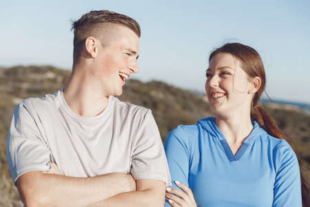 Young couple on beach wearing sportwearの写真素材