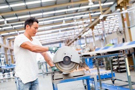 portrait of asian worker in production plant working on the factory floorの写真素材
