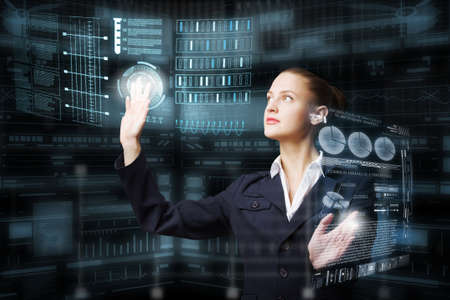 Attractive elegant businesswoman working with virtual panel interface