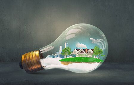 Think green concept with modern cityscape inside of light bulbの写真素材